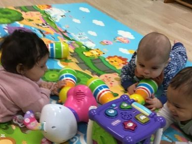 Babies joyfully engage in play time together at Gentog Intergenerational Daycare in Tigard, OR