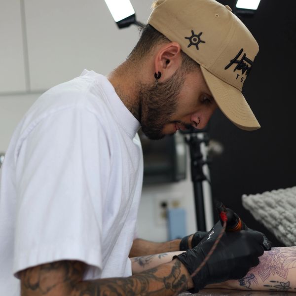 Tattoo artist working on a tattoo design.