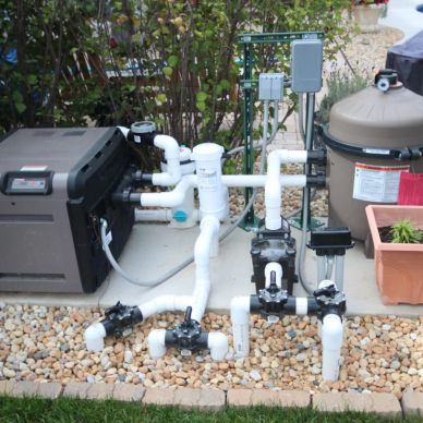 A backyard pool pump and filtration system setup.
