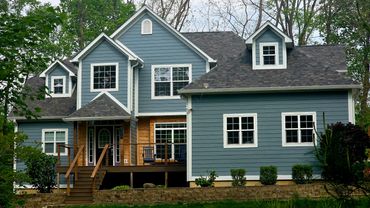 After picture. New deck, Hardie Plank siding, and gutters.
