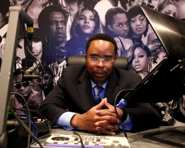 Reginald Mathis Suit on the chair and looking on the camera