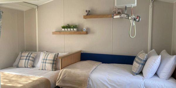 Profiling bed and H frame hoist in static caravan.