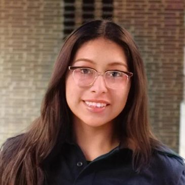 Young woman with glasses smiling.