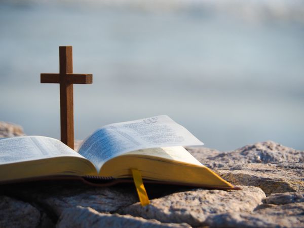 A wooden cross and a bible