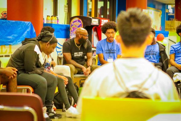 Group of young adults engaged in a discussion or workshop indoors.