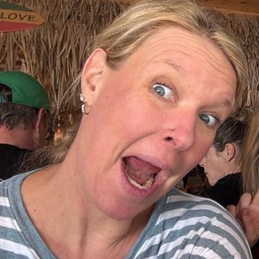 Woman making a surprised or excited facial expression indoors.