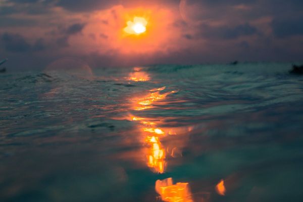 Sunset photo from the ocean with the light reflecting off of the water Topsail Island Southend