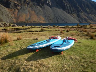 Explore the Lakes red Paddle boards at the lakeshore. 