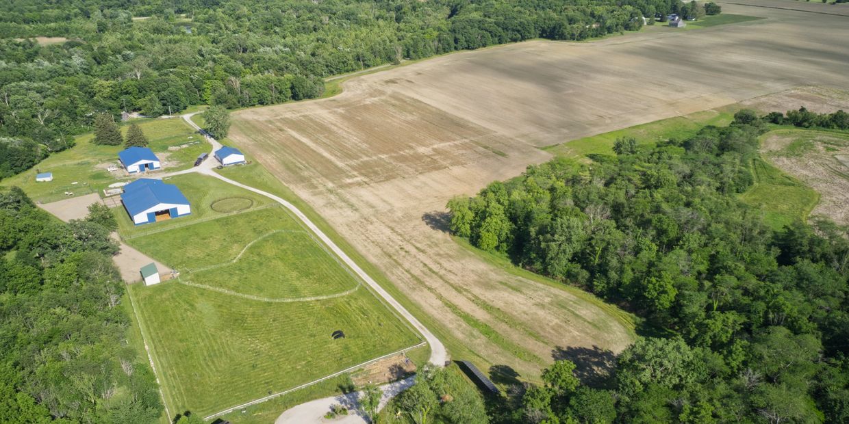 Aerial view of Bluestem Springs Farm, barns, house and pasture