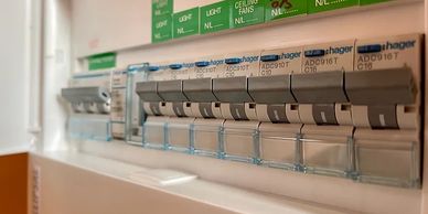 Close-up of electrical circuit breakers labeled Hager.