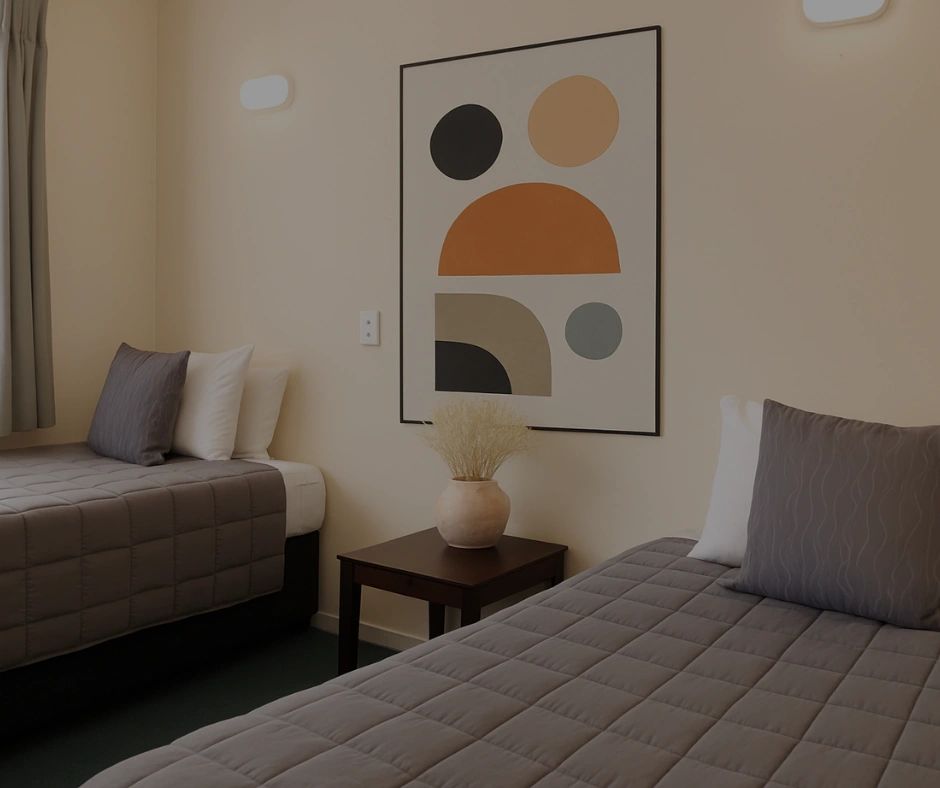 2 single beds with art work on wall 