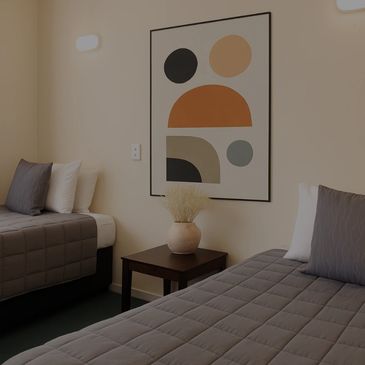 2 single beds with art work on wall 