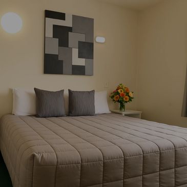 King bed with art work on wall 