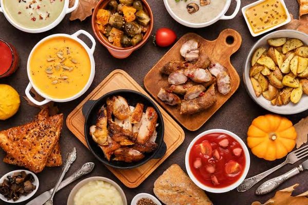 A spread of hearty dishes including roasted meats, soups, and roasted potatoes.