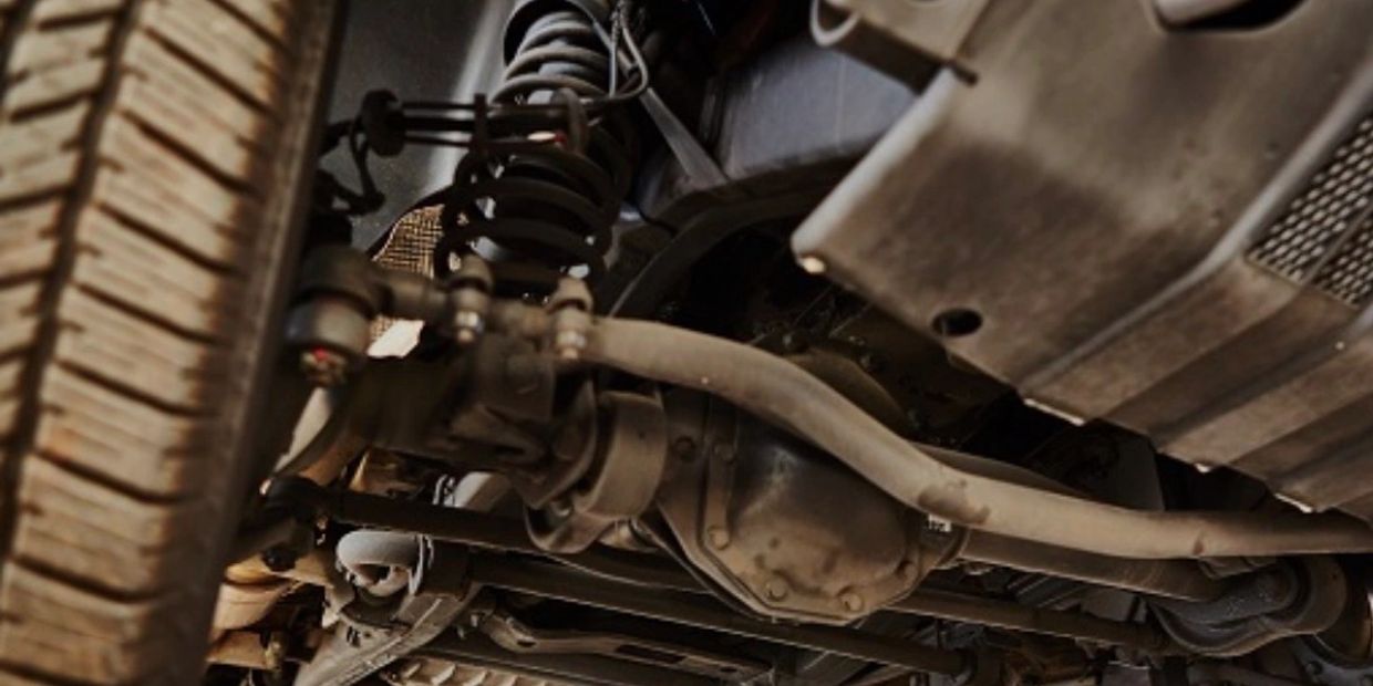 Close-up of a car's suspension system and undercarriage.