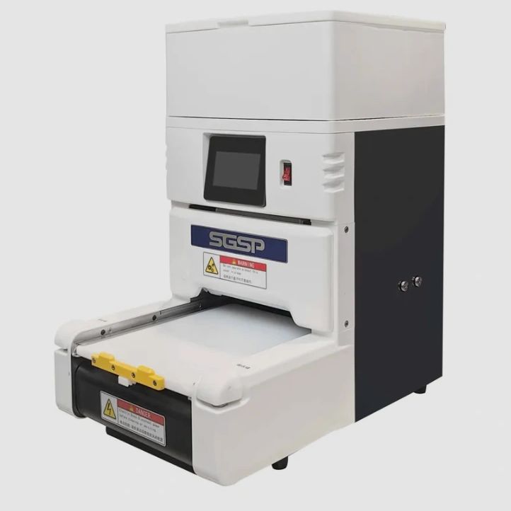 Compact industrial machine with digital interface and safety warnings.