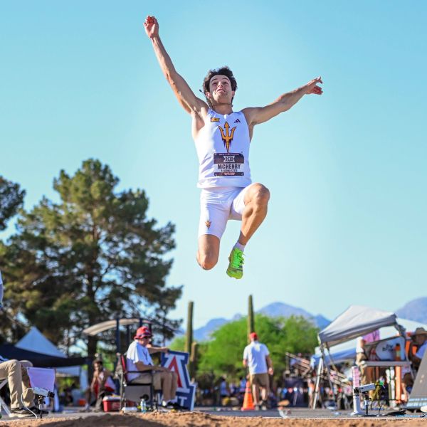 Athlete mid-air in a long jump event.