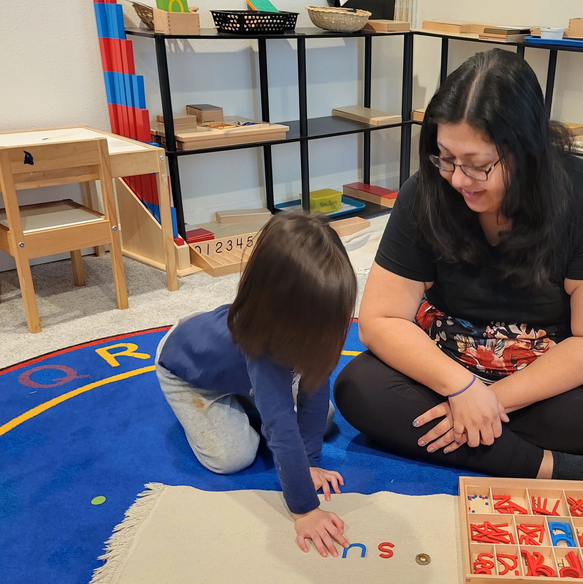Child building words using the Montessori movable alphabet.