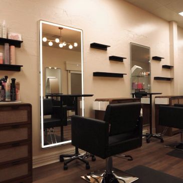 Modern salon interior with mirrors and chairs.