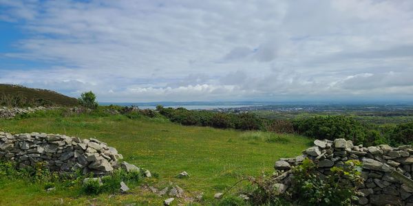 Rolling hills, ocean in the distance.