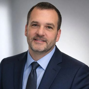 Professional man in dark suit and tie.