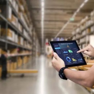 Person using tablet for warehouse robotics management.