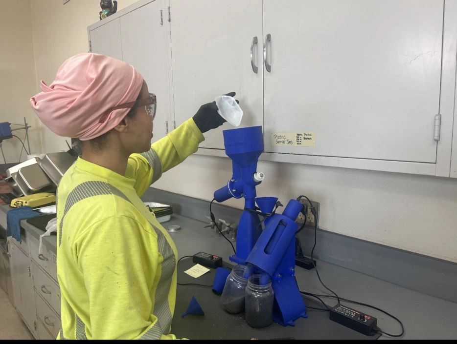 IMC personnel process a dried slurry sample through the MiningMagnets Collector as part of their magnetite-loss testing workflow. The automated separation helps reduce a roughly two-hour manual test to about ten minutes while allowing significantly more samples to be processed each day.