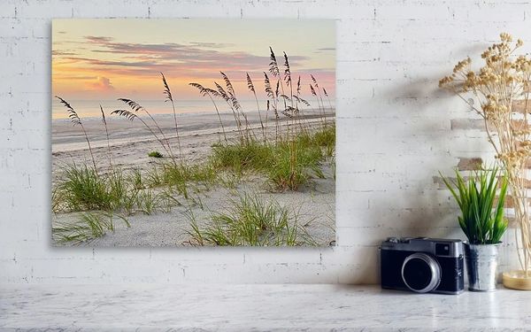 Sea Oats Sway
Soft hues of pink and orange paint the sky as the sun sets over a tranquil beach scene