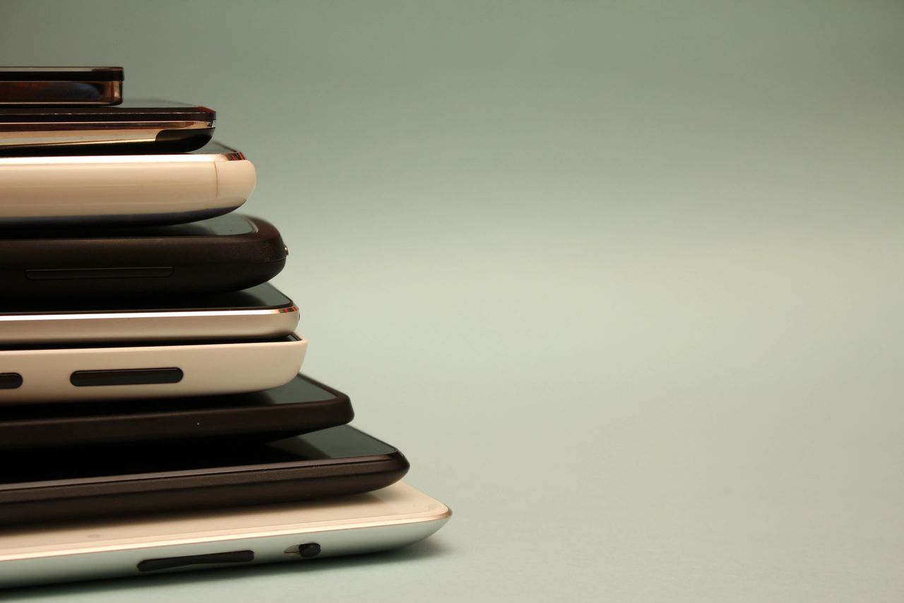 A stack of tablets and cellular phones. A stack of tablets and cellular phones.