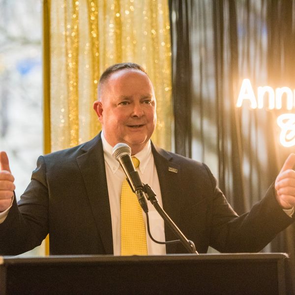 Dan Powell speaking at an awards ceremony in Rochester, NY.