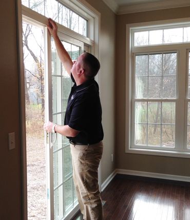 Dan Powell is checking a sliding door to make sure it locks properly.