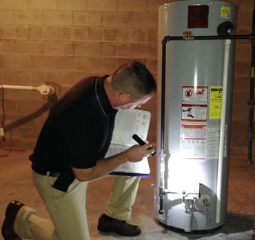 Dan Powell checks a water heater to make sure it is working properly.