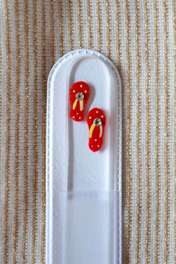 Red Fip Flops hand painted on a clear Crystal glass fingernail file. 