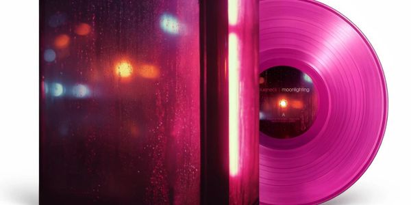 Pink vinyl record with a matching album cover featuring blurred lights.