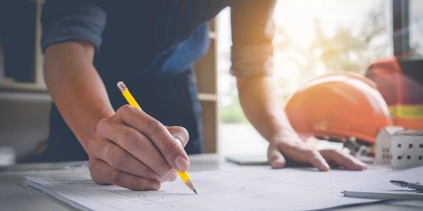 A person drawing on a sheet with pencil