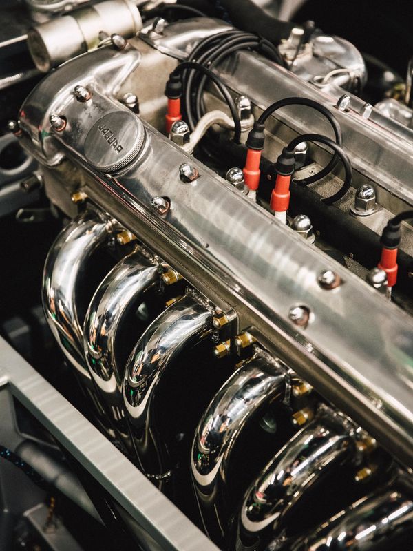 The iconic Jaguar straight-six engine with polished headers.