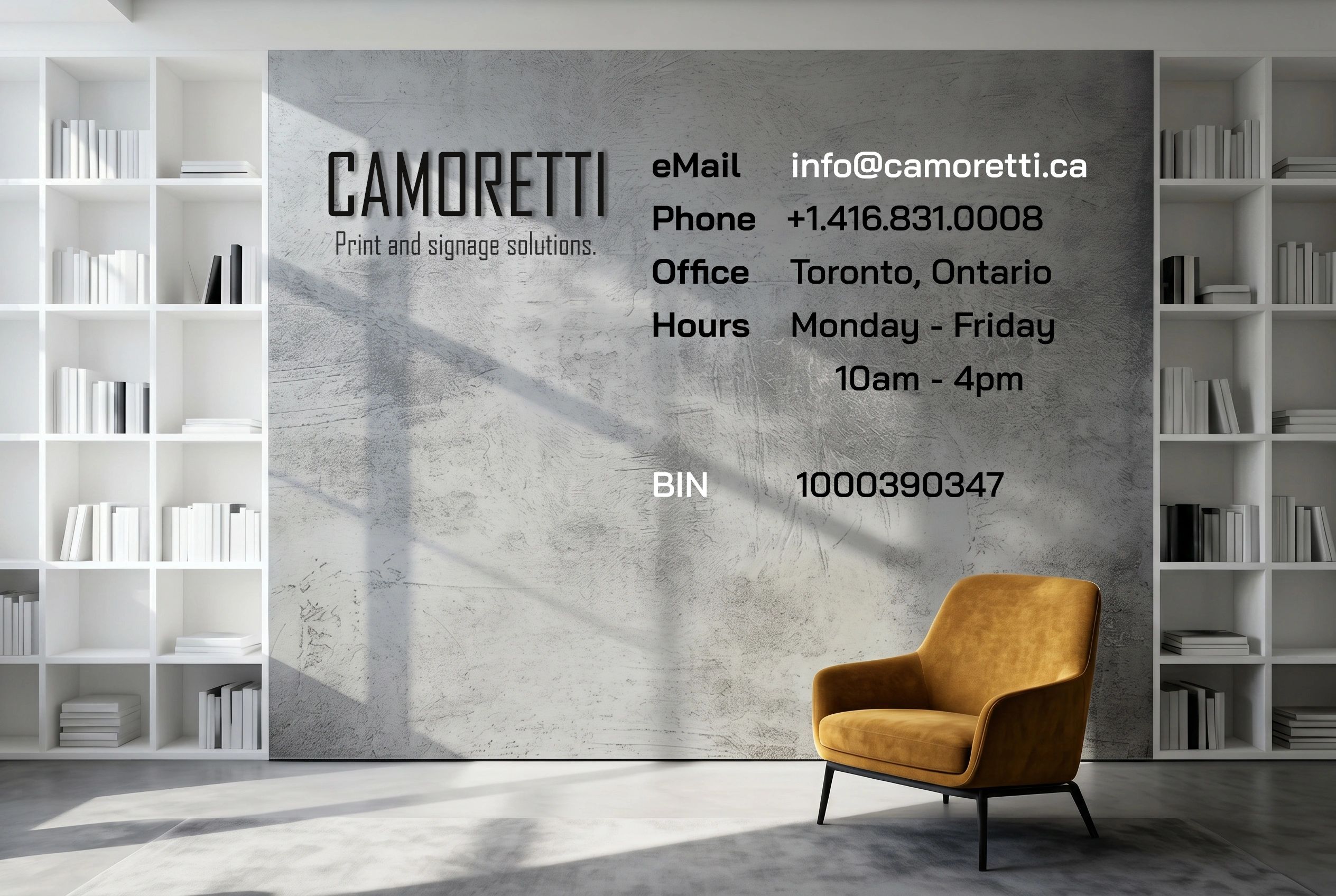 Modern office wall with contact info for Camoretti Print and Signage Solutions.