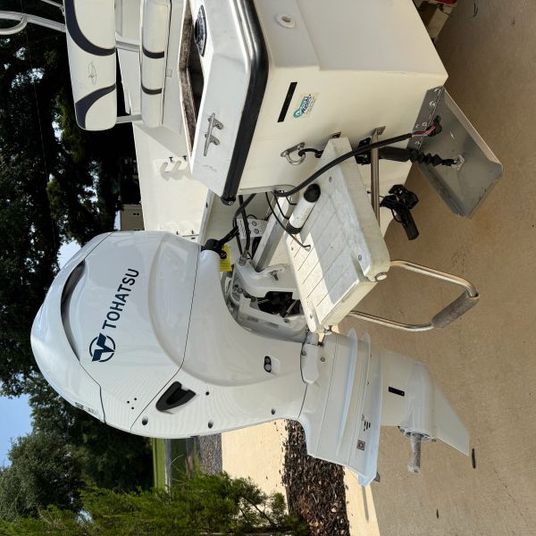 White Tohatsu outboard motor attached to a boat's stern.