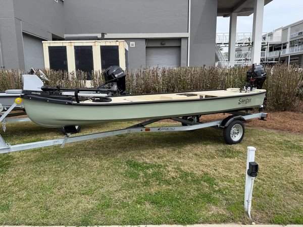 Light green fishing boat on a trailer.