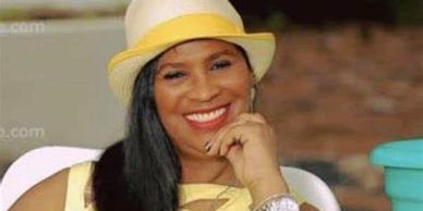 Tina Graham in yellow attire smiling.