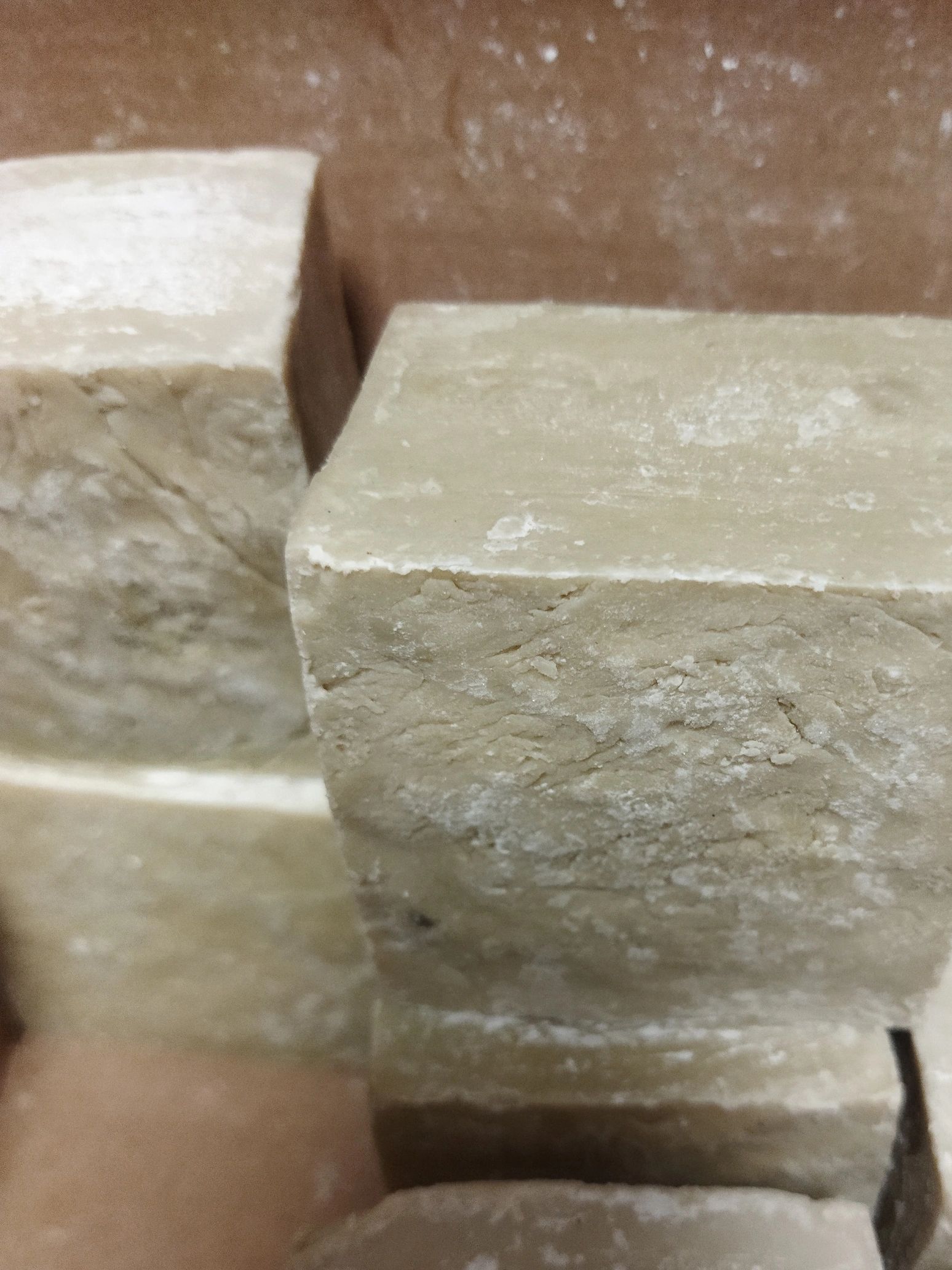 Close-up of rectangular beige soap bars.
