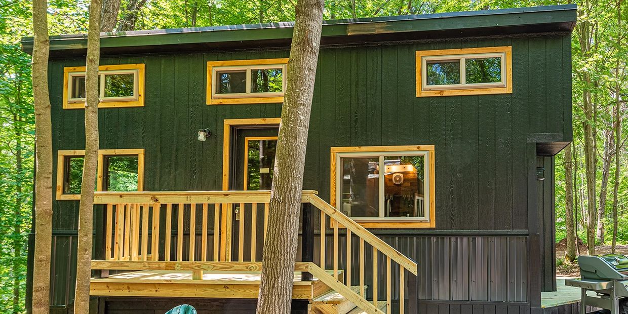 Custom built No Boundaries Tiny Home utilizing reclaimed & upcycled materials with deck & stairs.