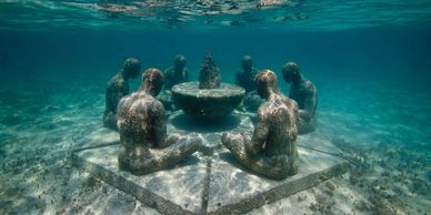 Captivating image of sculptures submerged in crystal-clear waters of MUSA Cancun Underwater Museum 