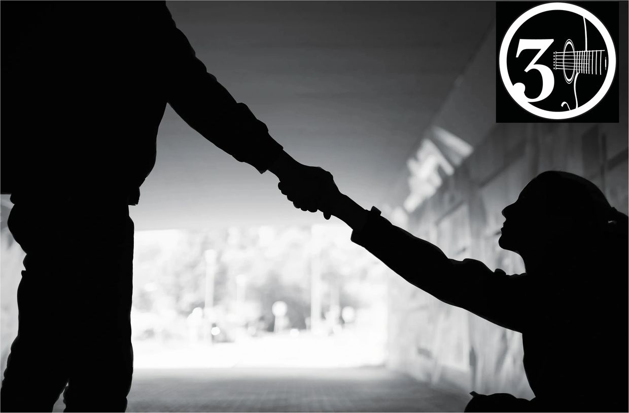 Silhouetted handshake between two people in a tunnel with a logo overlay.