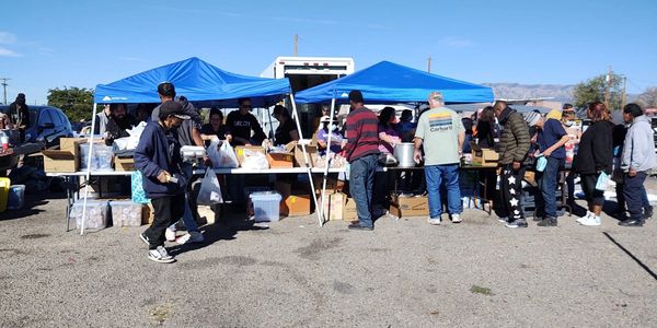 Recent Outreach - Folks in line waiting to be fed so they can can get themselves some clothing.