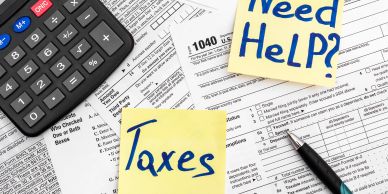 Tax forms with calculator and help notes.
