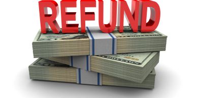 Refund text on stacked dollar bills.