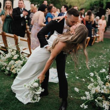 Couple dipping for a kiss after their ceremony at MacArthur Place in Sonoma, California