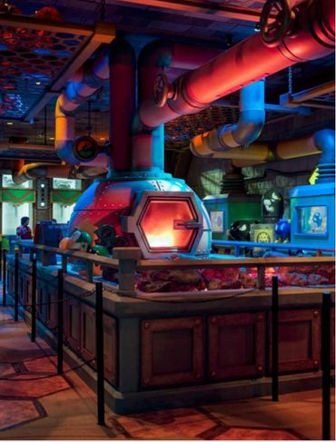 Colorful industrial oven in a themed kitchen or factory setting.