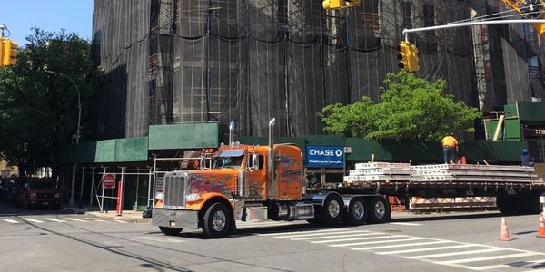 On site load of precast planking being transported throughout the city of New York.